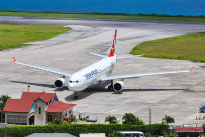 Airplane flying over airport runway