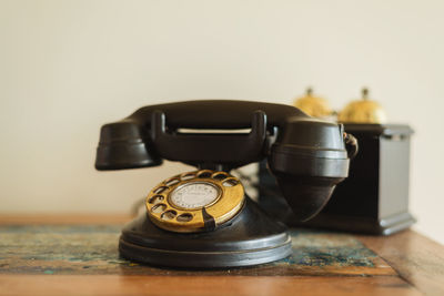 Close-up of old telephone on table