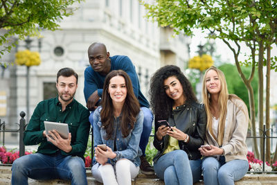 Group of people sitting on mobile phone