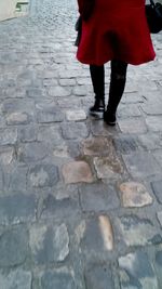 Low section of woman standing on tiled floor