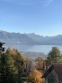 High angle view of trees and swiss mountains against blue sky