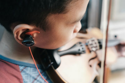 Midsection of boy playing violin