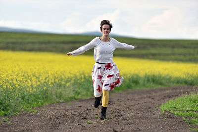 Young woman standing on field