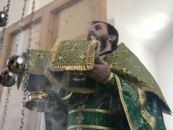 Low angle view of priest wearing traditional clothing standing in church