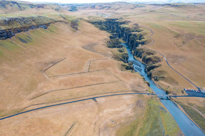 Winding blue riverbed flowing between rocks in iceland, natural amazing landscape. drone shot.