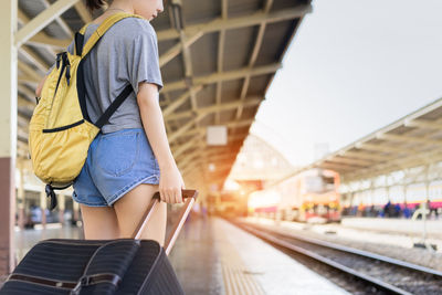 Midsection of woman at railroad station