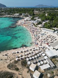 High angle view of townscape by sea against sky