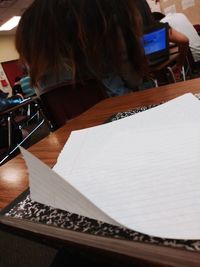 High angle view of woman reading book on table