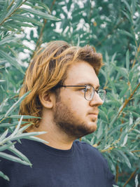 Portrait of a young man on a background of trees