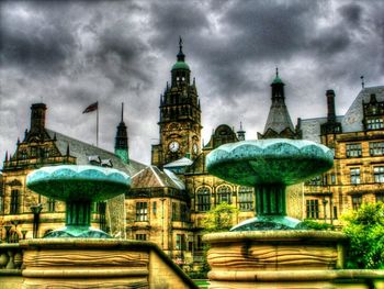 Buildings against cloudy sky