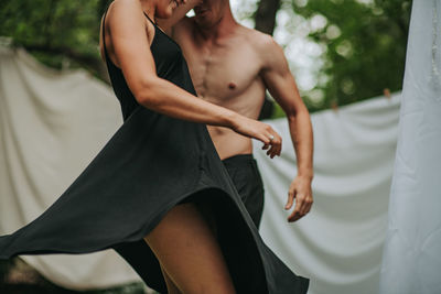 Midsection of couple holding hands