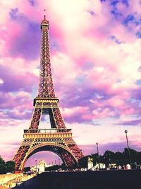 Low angle view of eiffel tower against cloudy sky