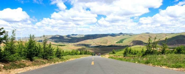 Empty road with mountains in background