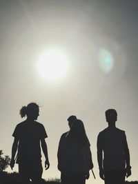 Rear view of silhouette people walking against sky