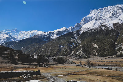 Scenic view of snowcapped mountains against clear sky