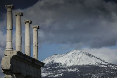 Low angle view of snowcapped mountain against sky