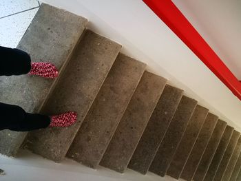 Low section of woman standing on staircase