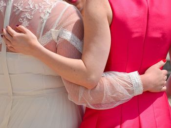 Midsection of woman wearing red dress