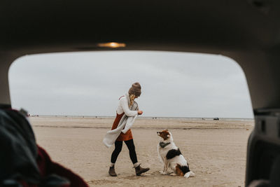 People on beach against sky