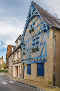 Exterior of building by road against sky