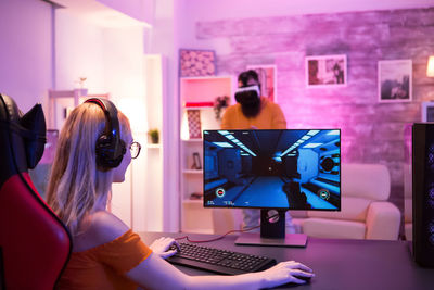 Portrait of young woman using laptop at home