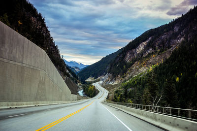 Road amidst mountains against sky