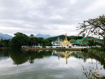 Scenic view of lake by building against sky