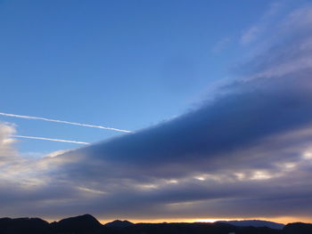 Scenic view of mountains against cloudy sky