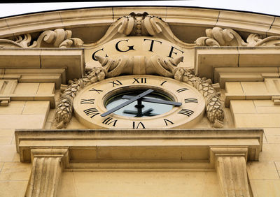 Low angle view of clock tower against building