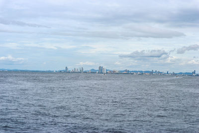 Panoramic view of sea and buildings against sky