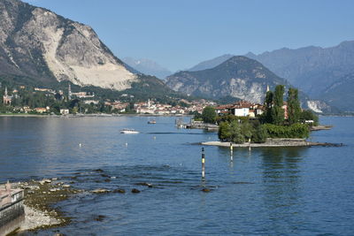 Scenic view of sea and mountains against clear sky