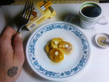 High angle view of hand holding food on table