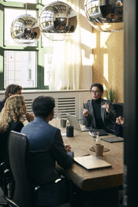 Portrait of woman sitting on table