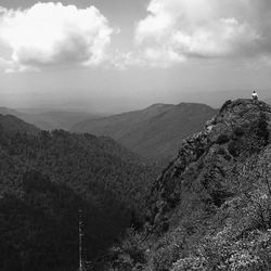 Scenic view of mountains against cloudy sky