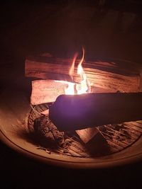 Close-up of burning candles on log