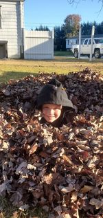 Portrait of boy with autumn leaves