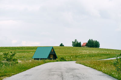 Built structure on field against sky