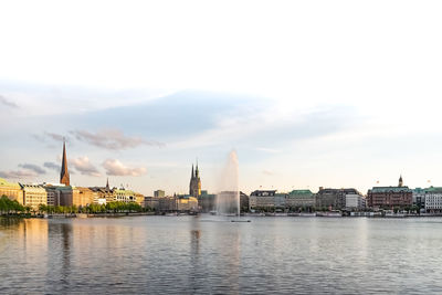 River by buildings against sky in city