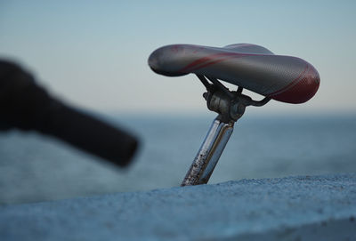 Low angle view of a bicycle seat against sky