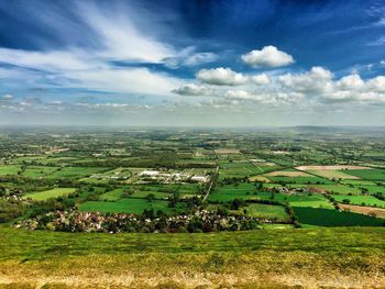 Scenic view of field against cloudy sky