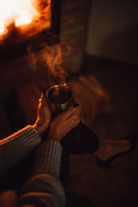 Midsection of man holding coffee cup