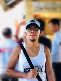 Portrait of young man wearing sunglasses standing outdoors