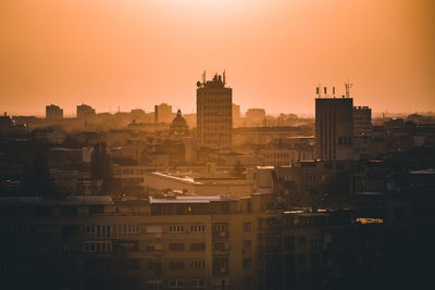 View of buildings in city at sunset