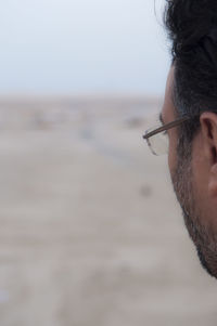 Close-up of senior man wearing eyeglasses on field