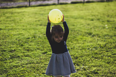 Girl playing with ball on field