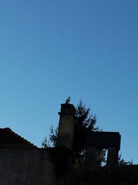 Low angle view of built structure against clear blue sky