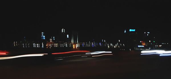 Light trails on road in city at night