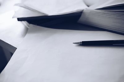 Close-up of pen and paper on table