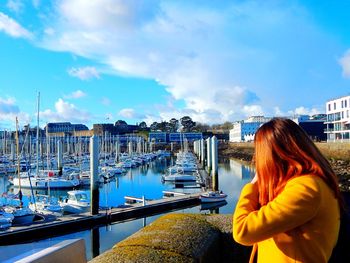 Woman standing in front of sea against clear sky