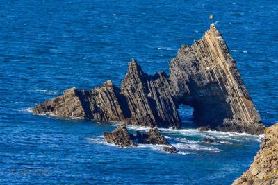 Scenic view of sea against rocks